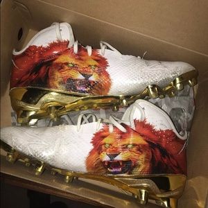 Adidas uncaged cleats. Gold bottoms lion